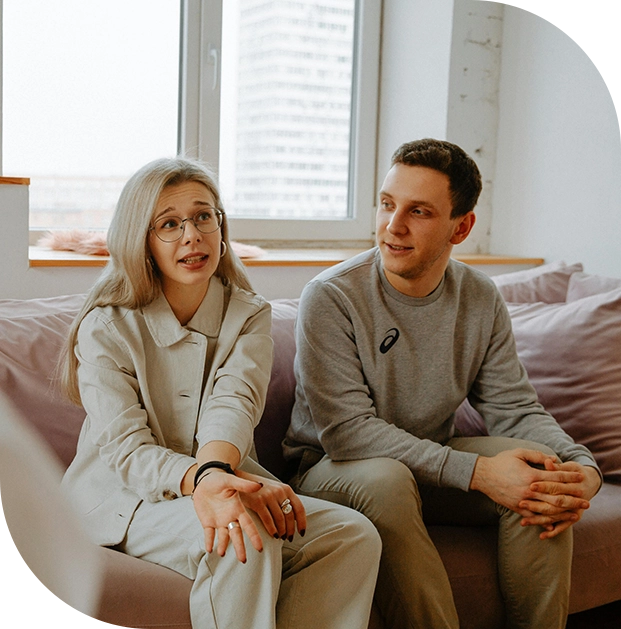 A man and woman sitting on top of a couch.