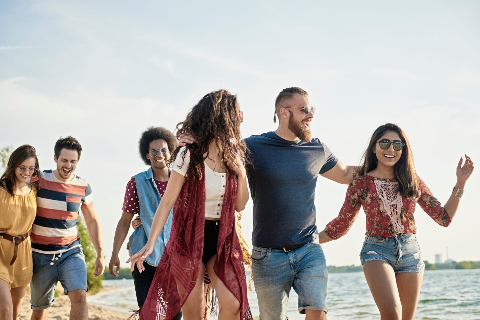 A group of people walking on the beach