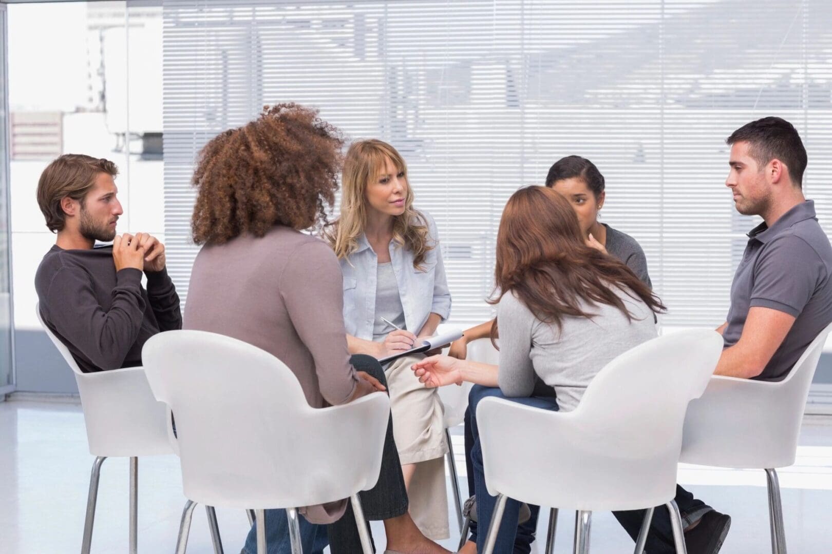 Group discussion in a bright, modern room.