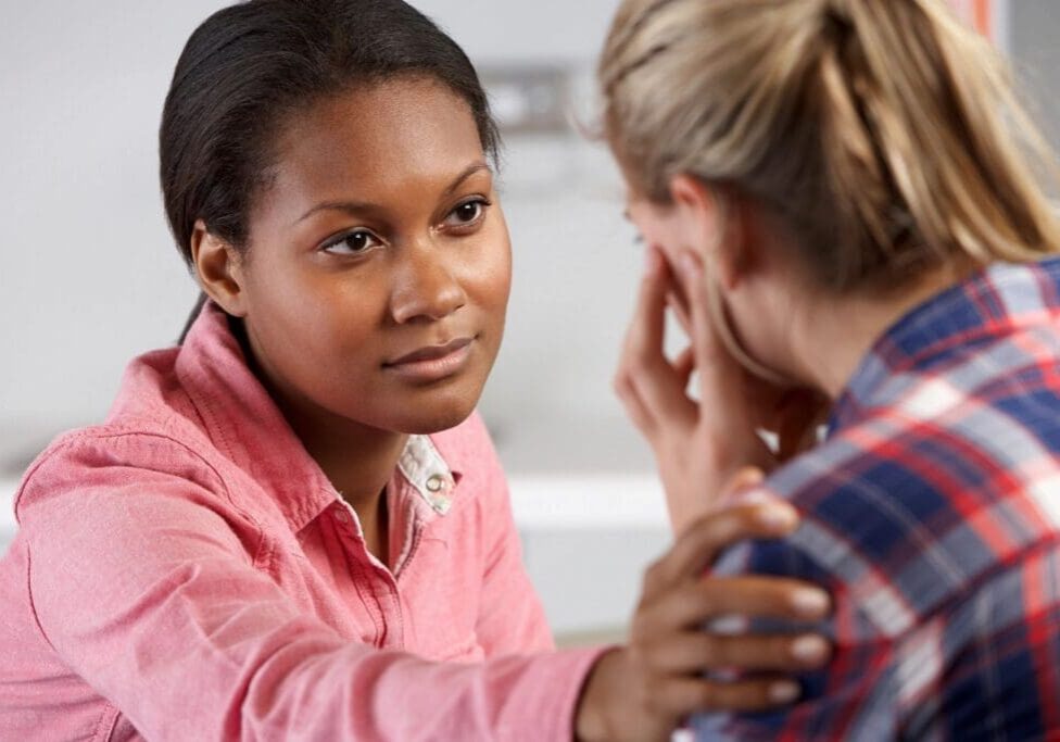 A woman is talking to another person in front of her.