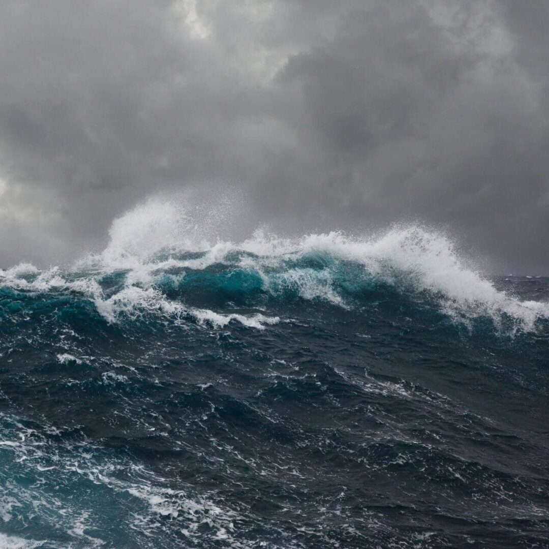 Stormy ocean waves under dark cloudy sky